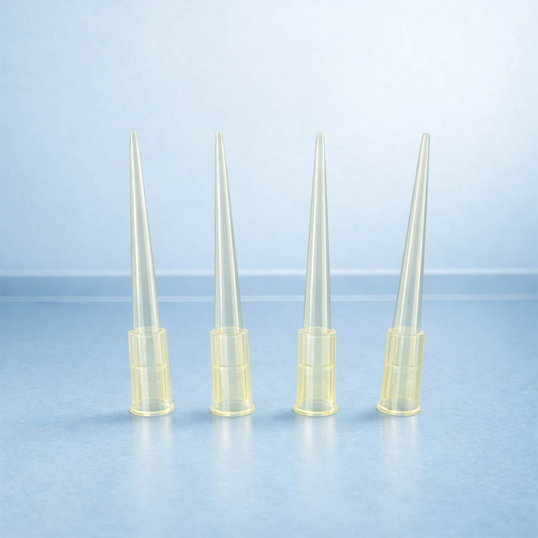 Four clear plastic pipette tips on a light blue background